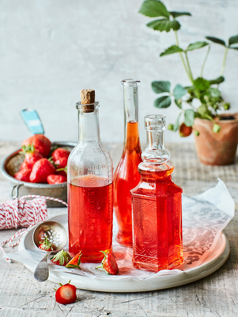 Selbstgemachter Erdbeeressig in dekorativen Glasflaschen