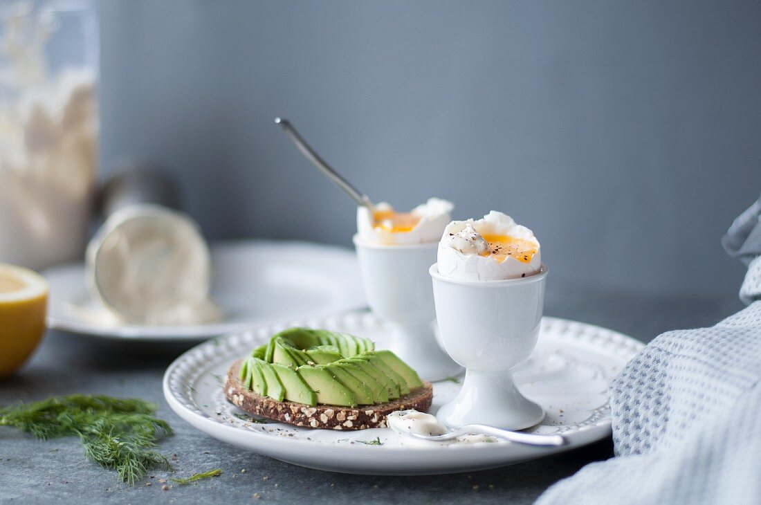Soft boiled eggs and toast with avocado