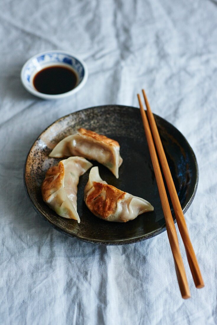 Gyoza with soy sauce and chopsticks (Japan)