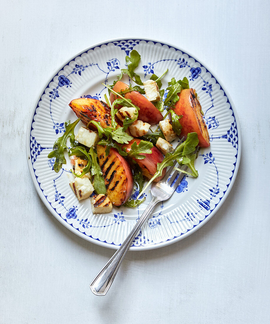 A summer salad with grilled halloumi, peaches and rocket