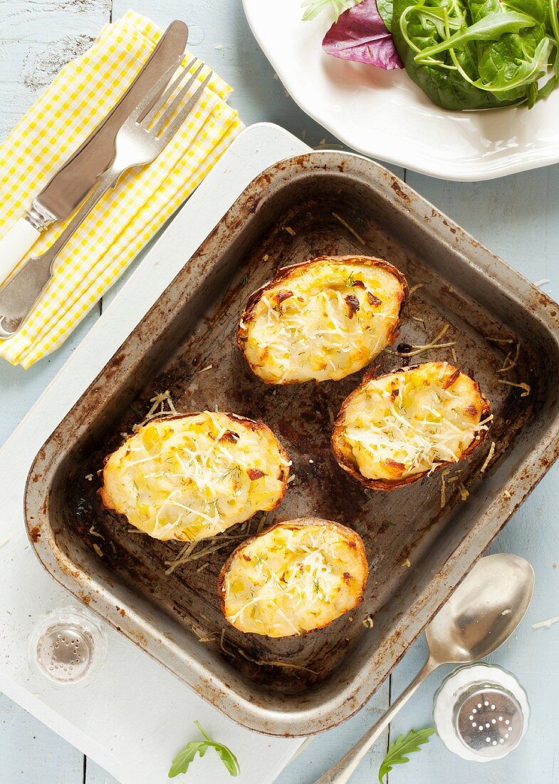 Baked potato halves filled with cheese and leek