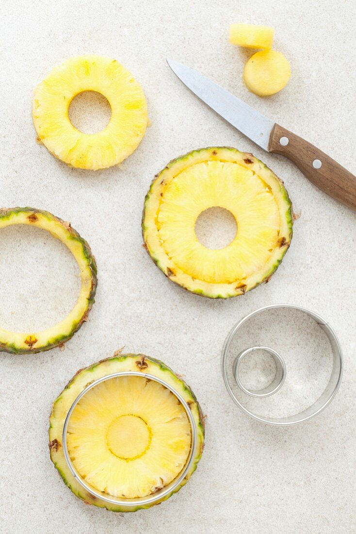 Fresh pineapple rings being cut out