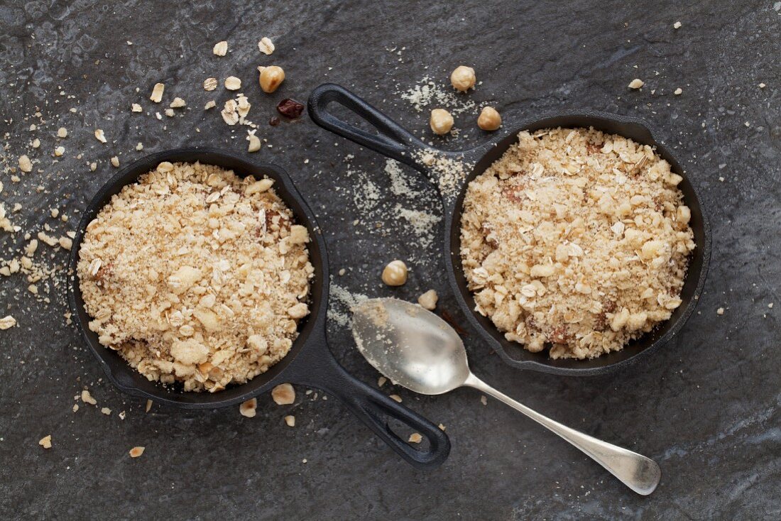 Chocolate and pear crumble in cast iron skillets (before baking)