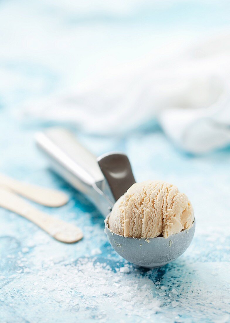 Salted caramel ice cream on an ice cream scoop