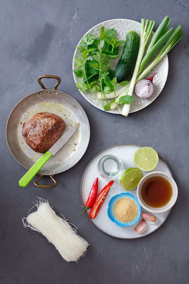 Ingredients for Thai salad: beef tenderloin, cucumber, glass noodles, chilli, lime, fish sauce and herbs