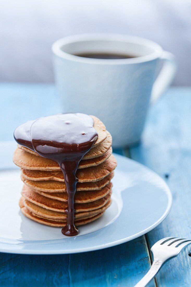 A stack of pancakes with chocolate sauce