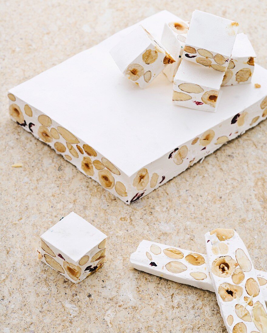 White nougat with nuts on a stone background