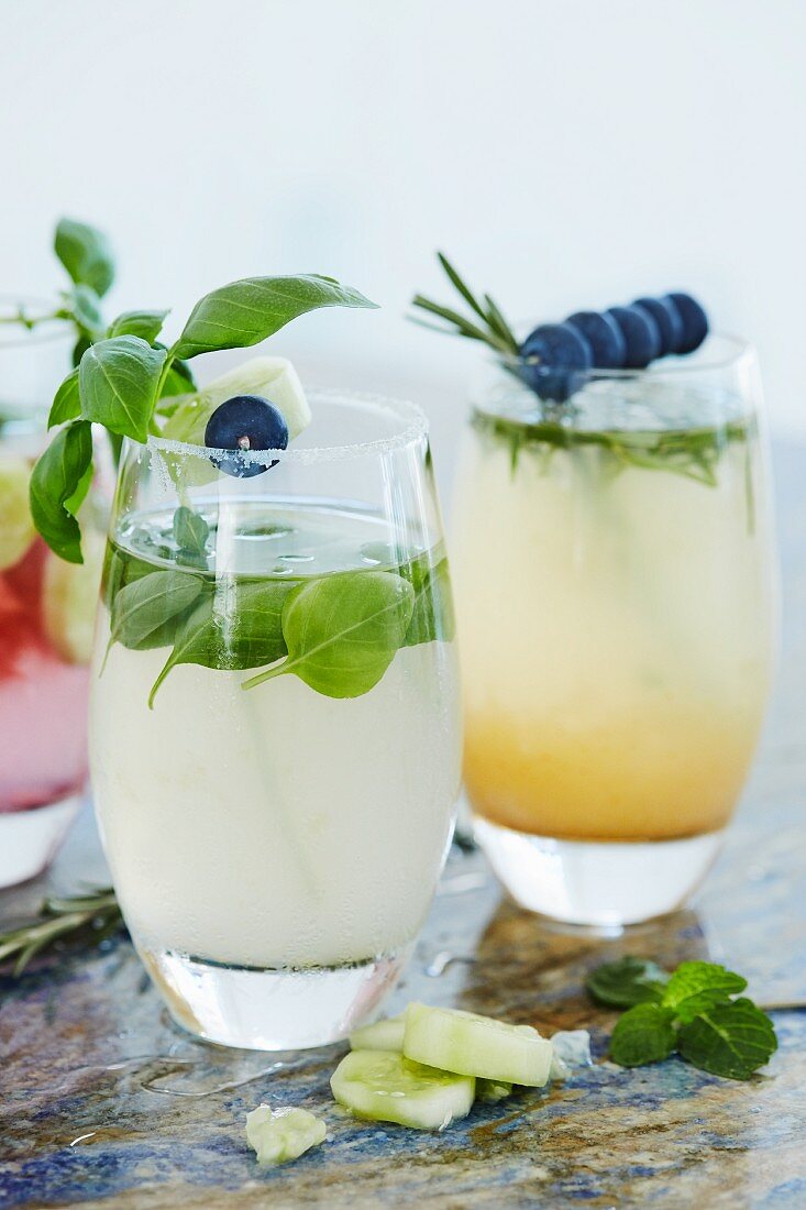 Cocktails with cucumber, basil, rosemary and blueberries