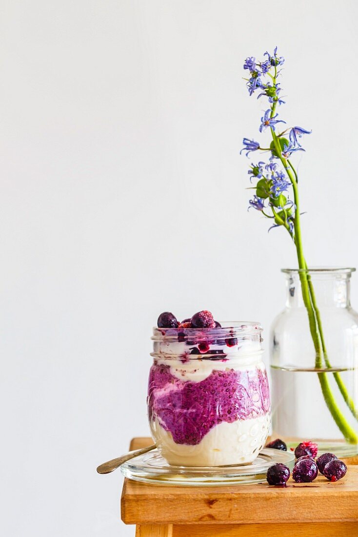 Breakfast in a glass with blueberry and chia pudding and yoghurt