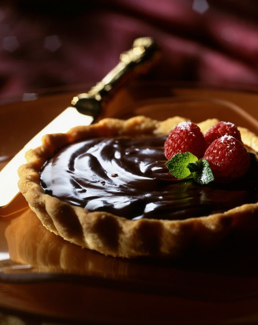 A chocolate tart with raspberries (close-up)