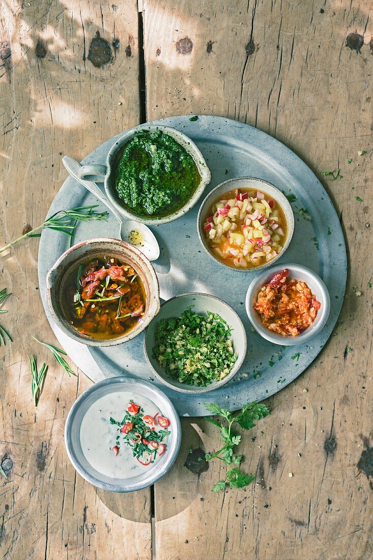 Coconut and chilli sauce, tomato and rosemary oil, herb and pistachio pesto, chervil and pine nut gremolata, radish and cucumber salsa and ginger and chilli paste