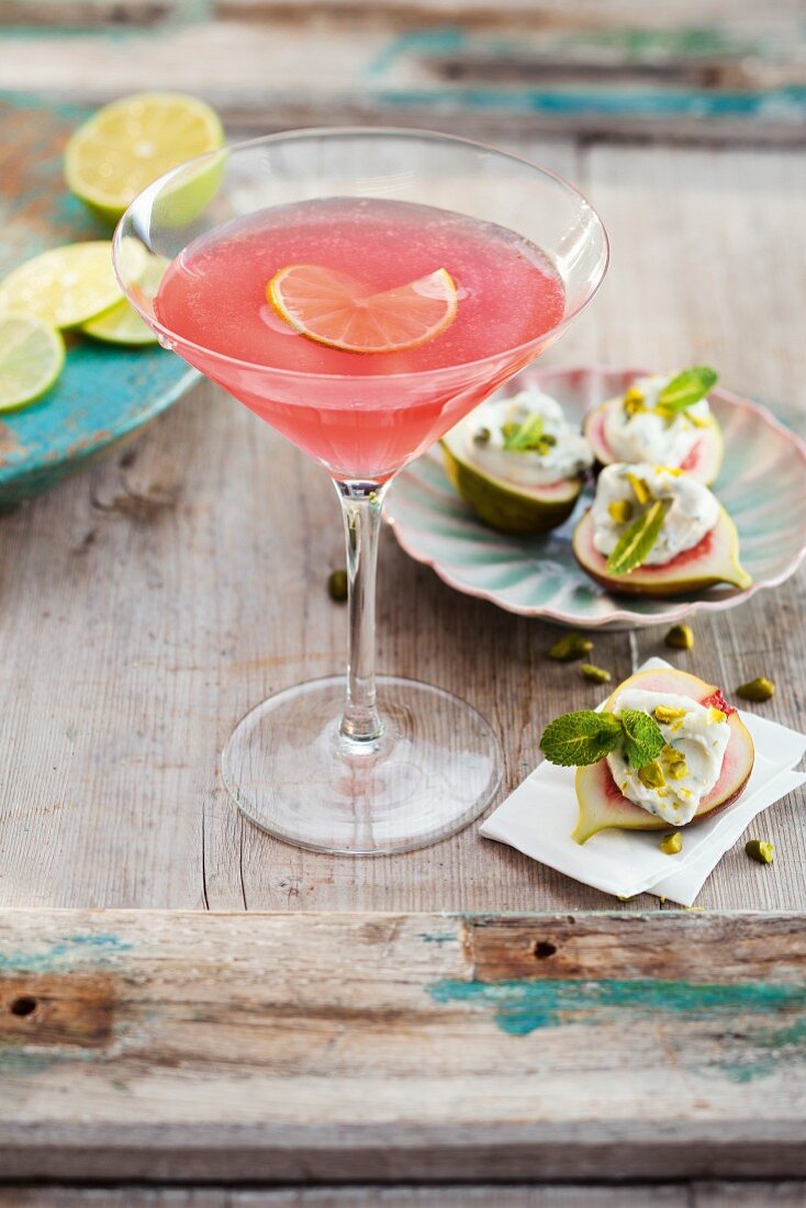 A Cosmopolitan cocktail served with fresh figs and soft goat's cheese