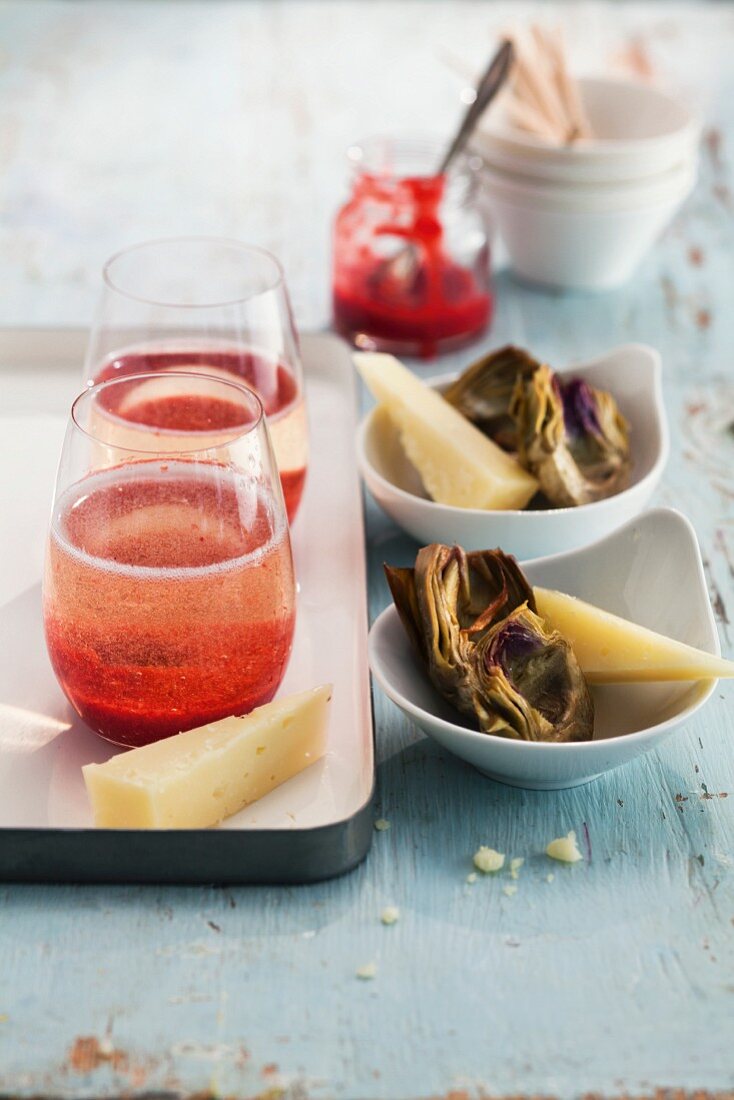 Strawberry and champagne cocktails served with artichokes and pecorino