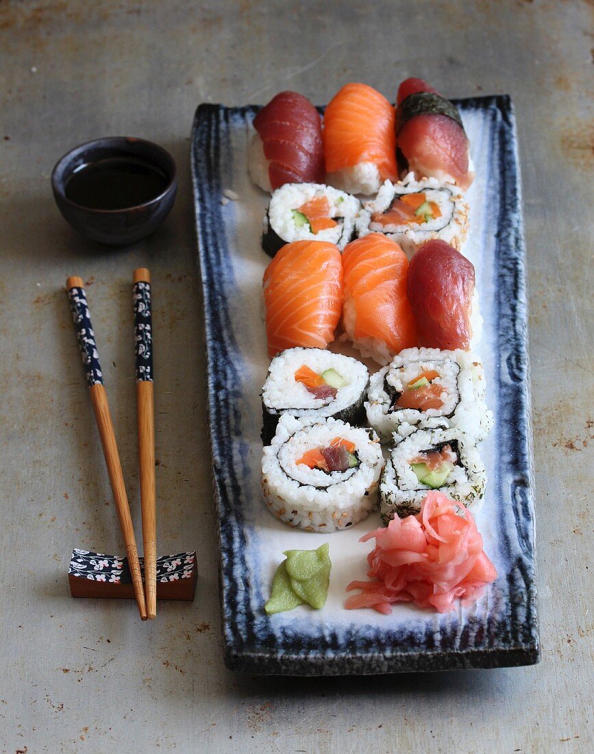 Various types of sushi with wasabi, ginger and soy sauce