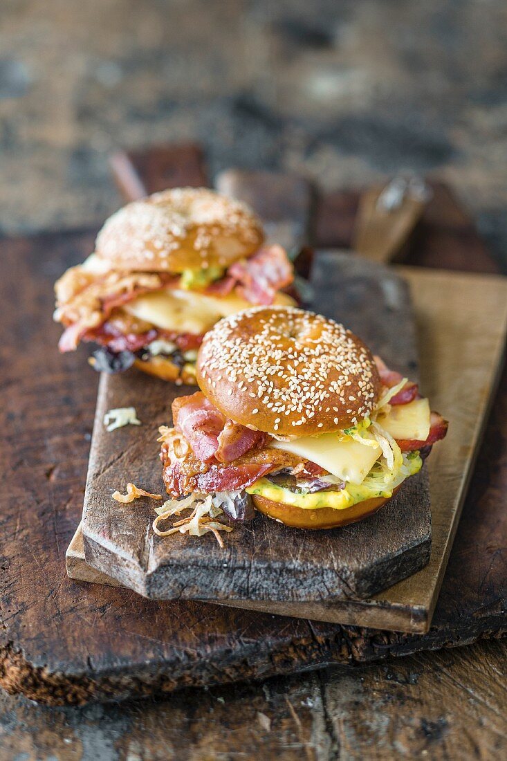 A sesame bagel with BBQ meat and mountain cheese