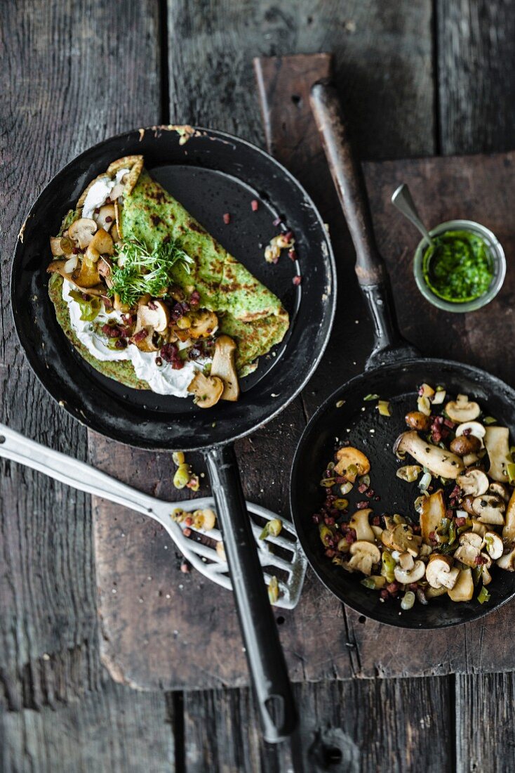 Broccoli and wild garlic pancakes with mushrooms in a frying pan