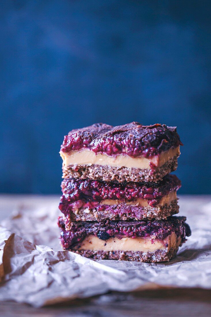 Stack of raw peanut butter and raspberry chia jam bars