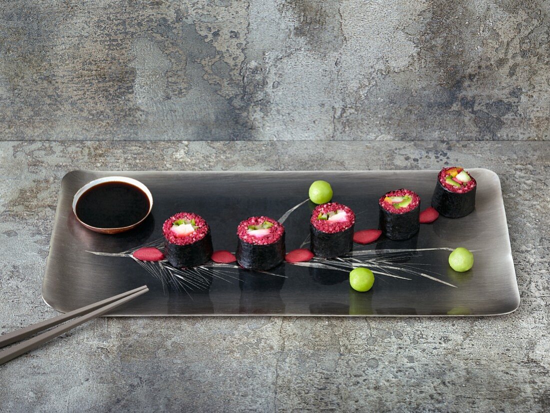 Quinoa sushi with smoked salmon, dyed in beetroot juice