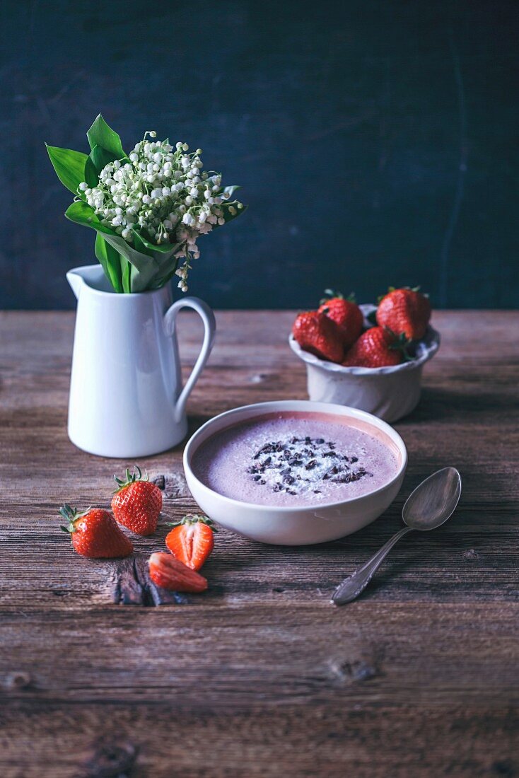 Strawberry banana smoothie bowl topped with coconut and cacao nibs