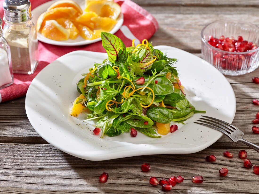 Wild herb salad with oranges and pomegranate seeds