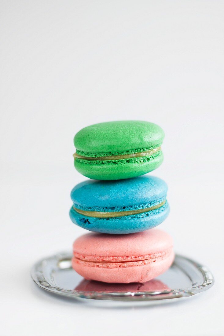 Homemade colourful French macarons with lemon curd
