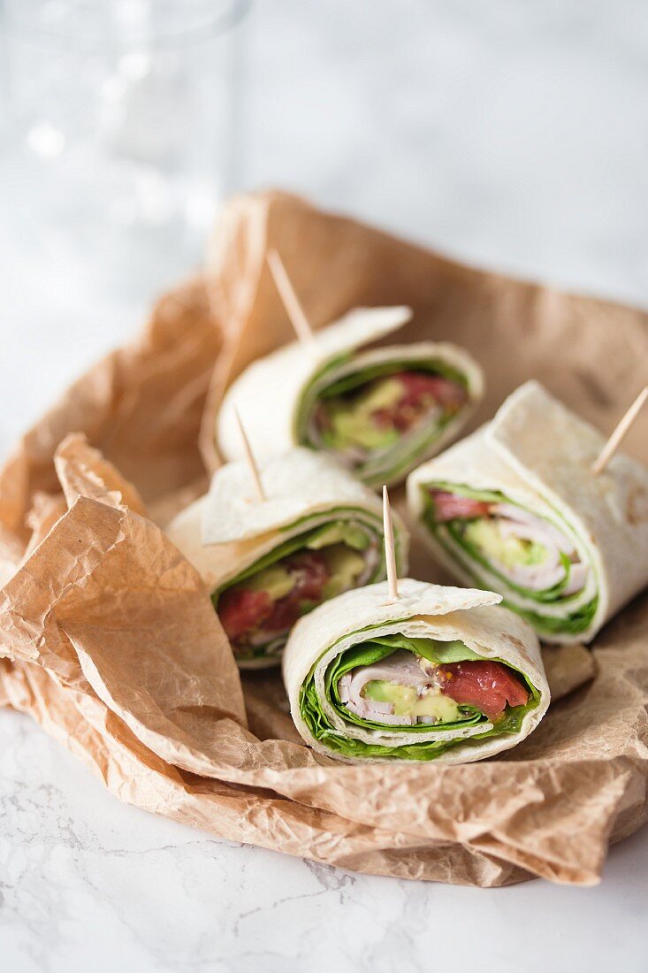 Tortilla rolls with lettuce, spinach, ham, avokado and tomatoes