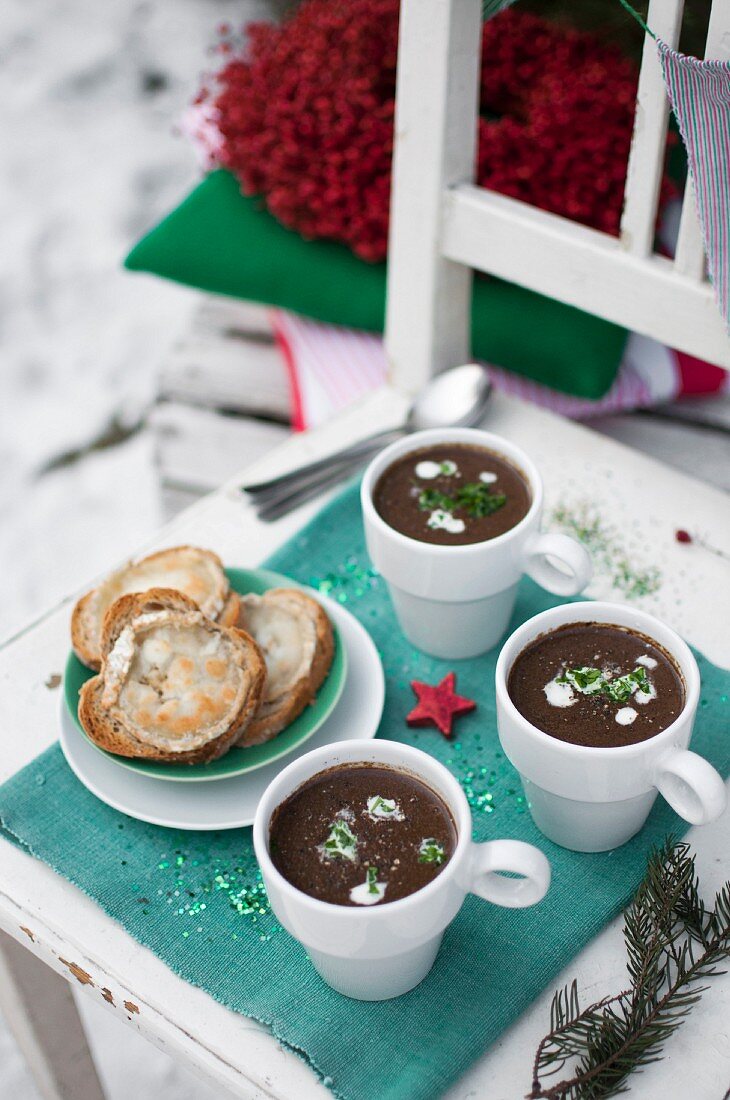 Christmas cream soup made with porcini mushrooms, topped with sour cream and chopped fresch lovage