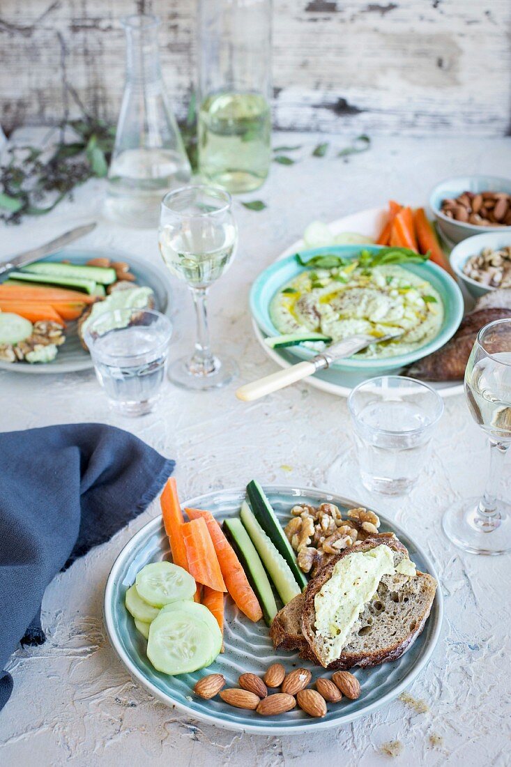 Meyer Lemon Basil Hummus served with vegetables, bread and white wine