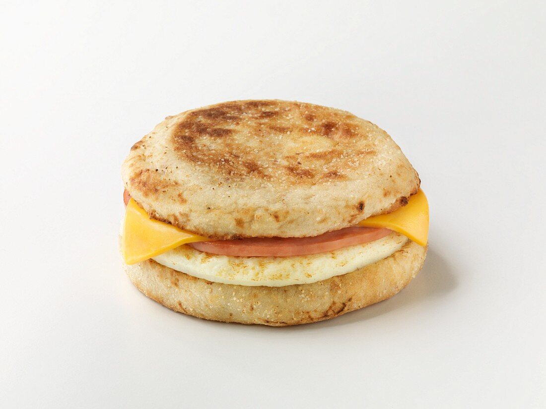 An English muffin with sausage and cheese