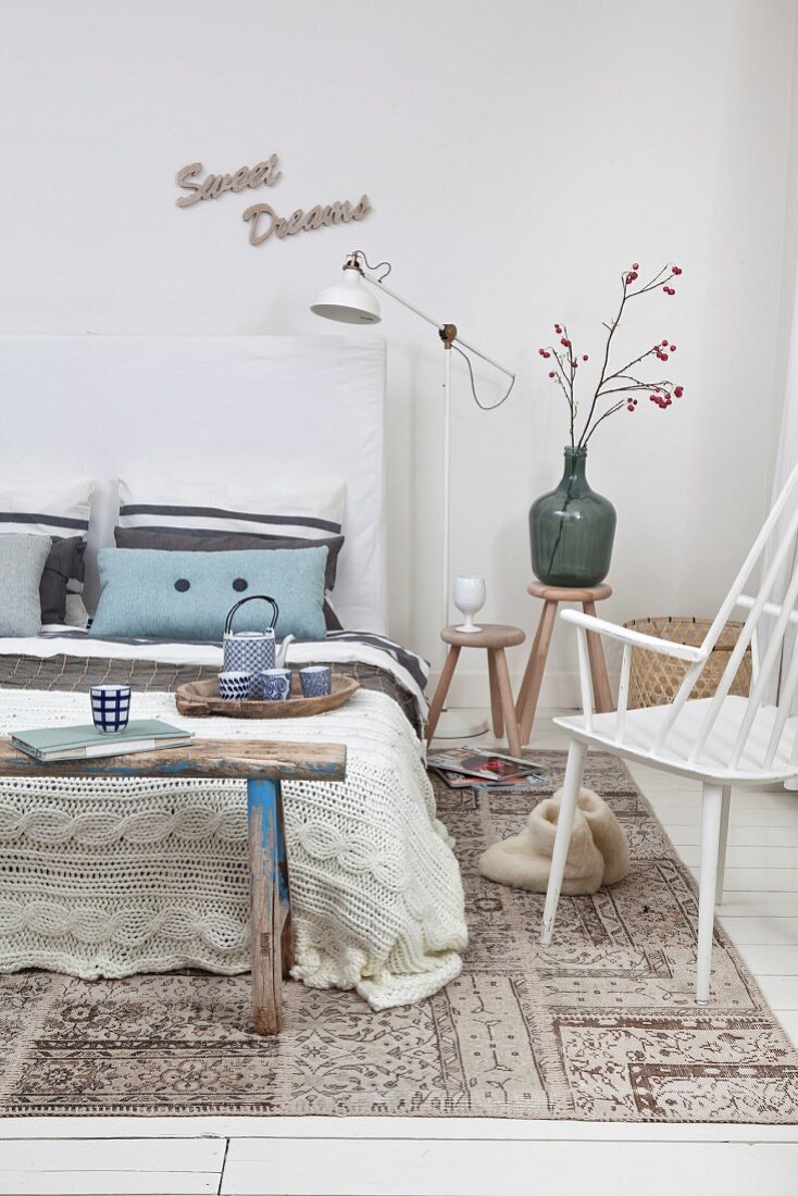 Schlafzimmer mit Vintage Holzbank und gestrickter Tagesdecke