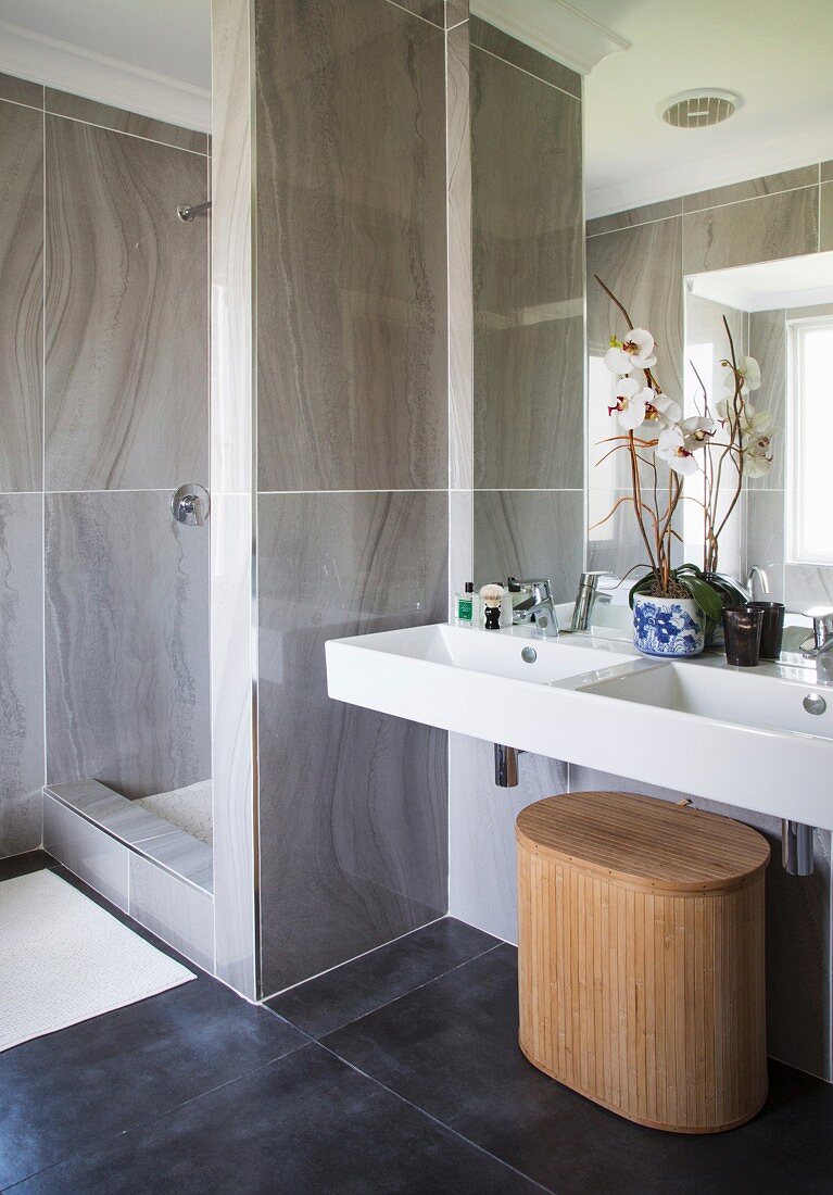 Shower area and white twin sinks in elegant bathroom