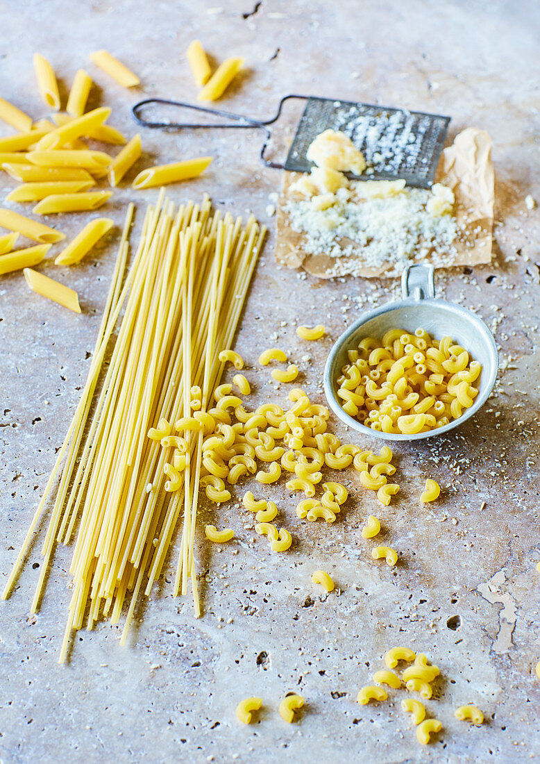 Various types of pasta and grated cheese