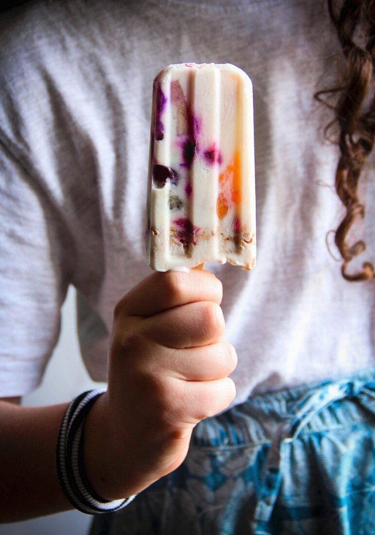 Girl holding an ice lolly