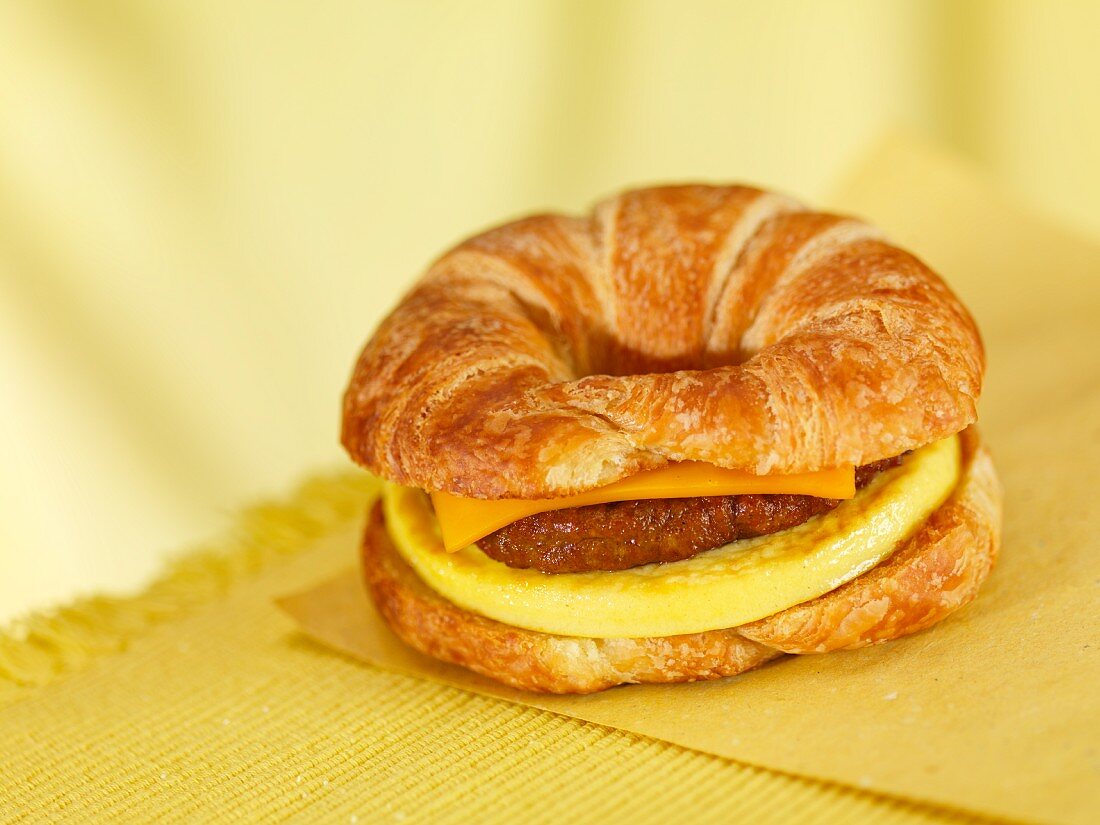 A croissant 'burger 'with cheese and omelette