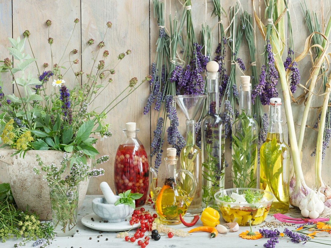 Still life with herbs, herb oil, and pickled sheep's cheese