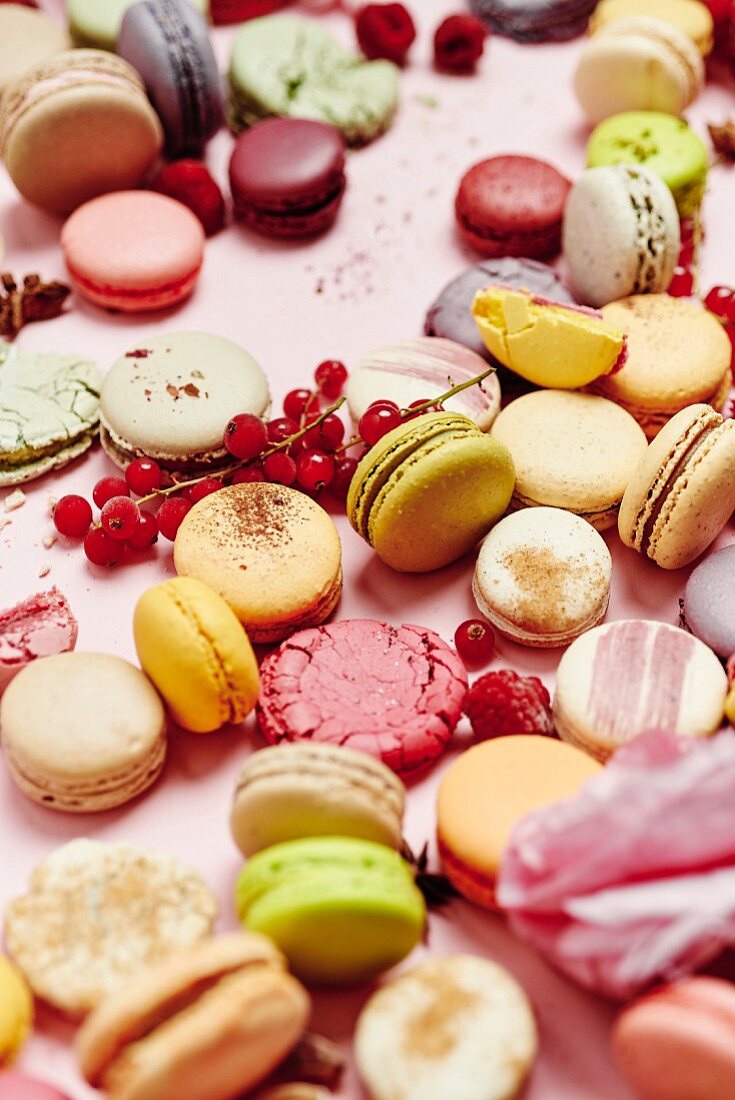 Still life of different varieties of French macarons on a pink background