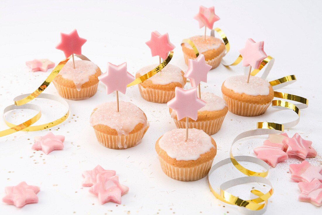 Muffins with pink icing and marzipan stars