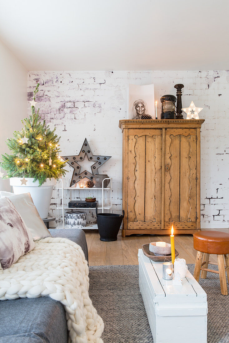 Wooden cupboard against brick wall and Christmas decorations in living room