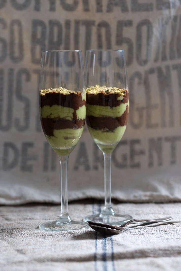Vegan chocolate and avocado crème desserts with chopped pistachios