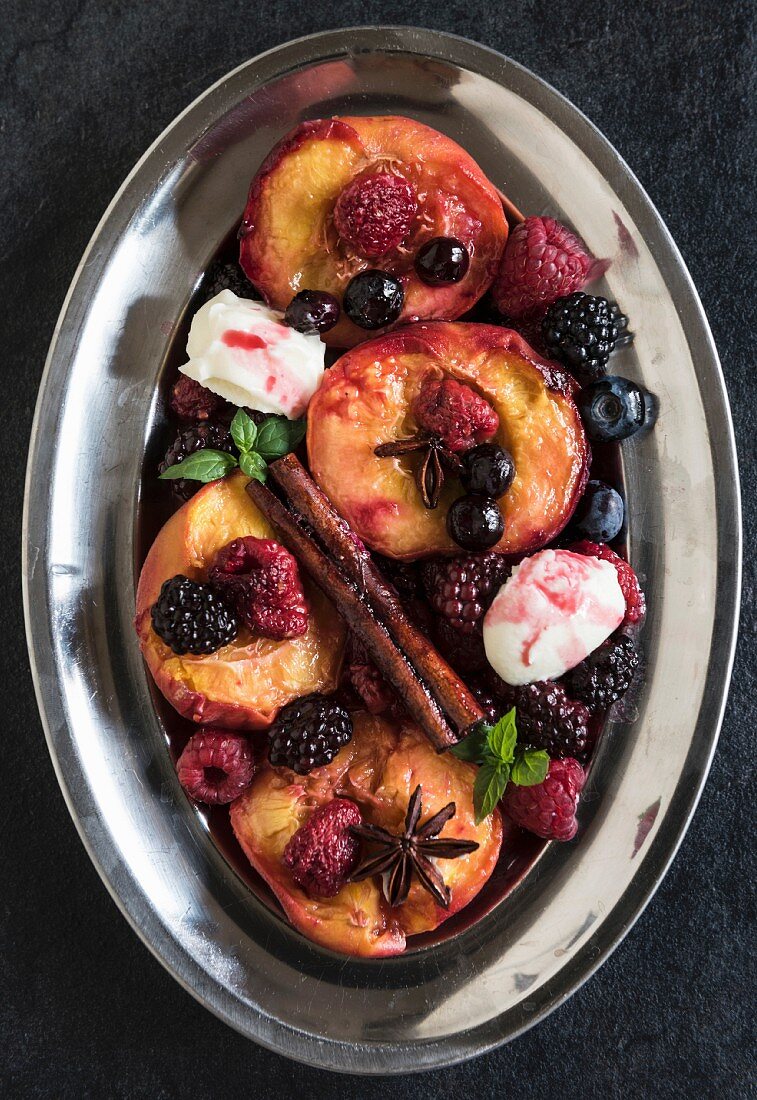 Grilled berries and peaches with mascarpone cheese cream in plate