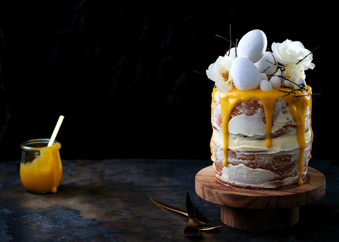 A layer cake glazed with cream cheese and lemon curd for Easter