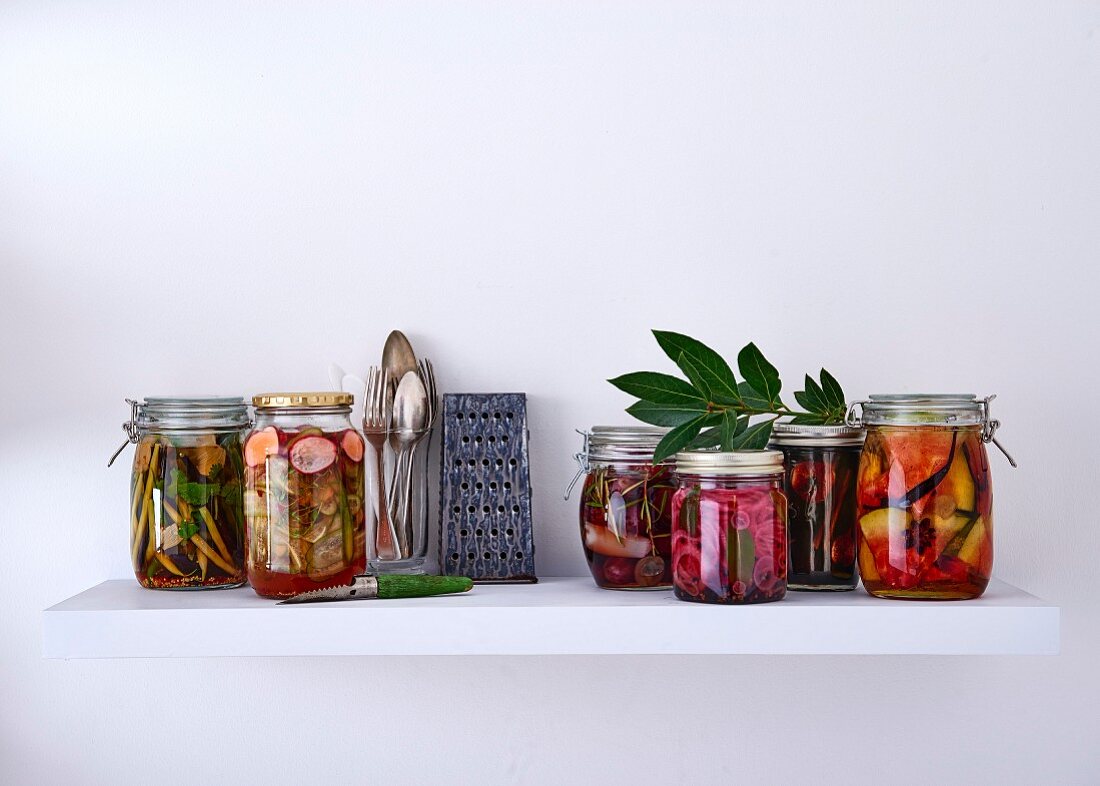 Various pickling jars with vegetables and fruit