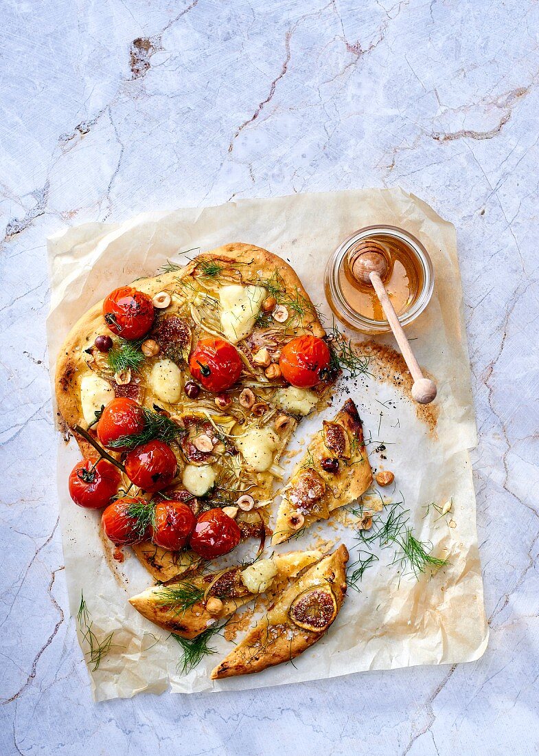 Brioche pizza with fennel, cherry tomatoes, bocconcini, figs and hazelnuts