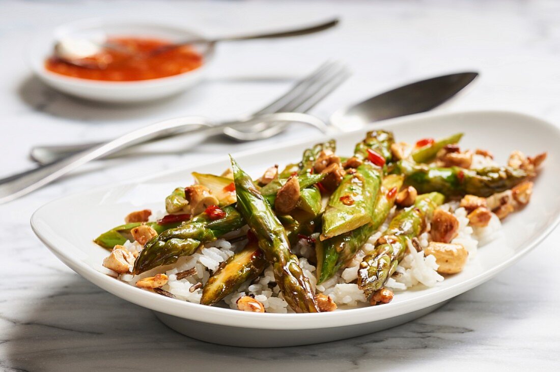 Fried green asparagus in sweet and spicy sauce with cashews on basmati and wild rice
