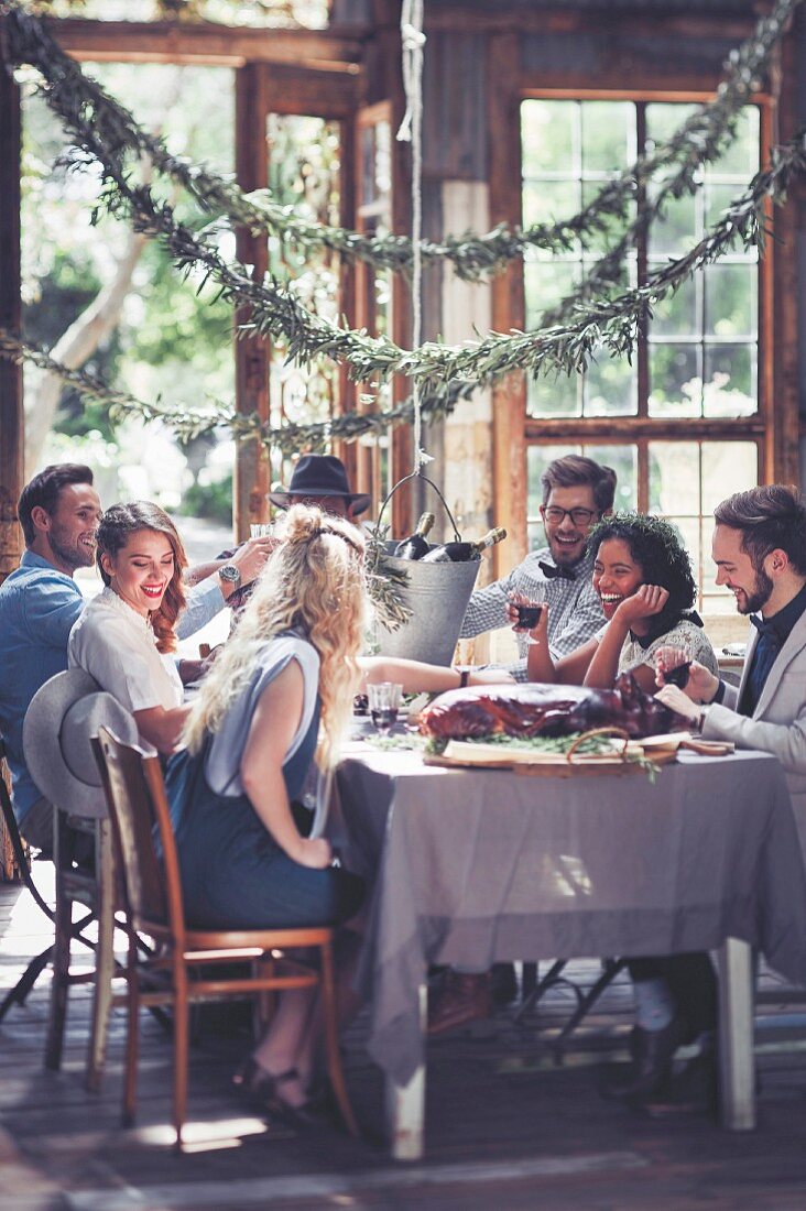 Friends sitting at a table set for Christmas