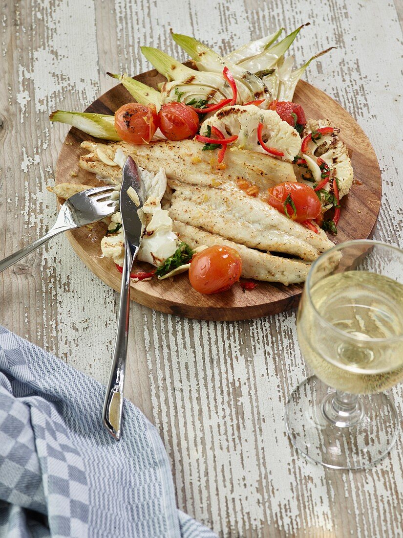 Grilled barramundi with fennel, cauliflower, cherry tomatoes and chillies