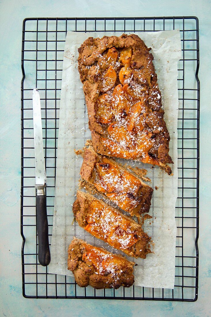 Whole wheat cake with apricots on a cooling rack (top view)