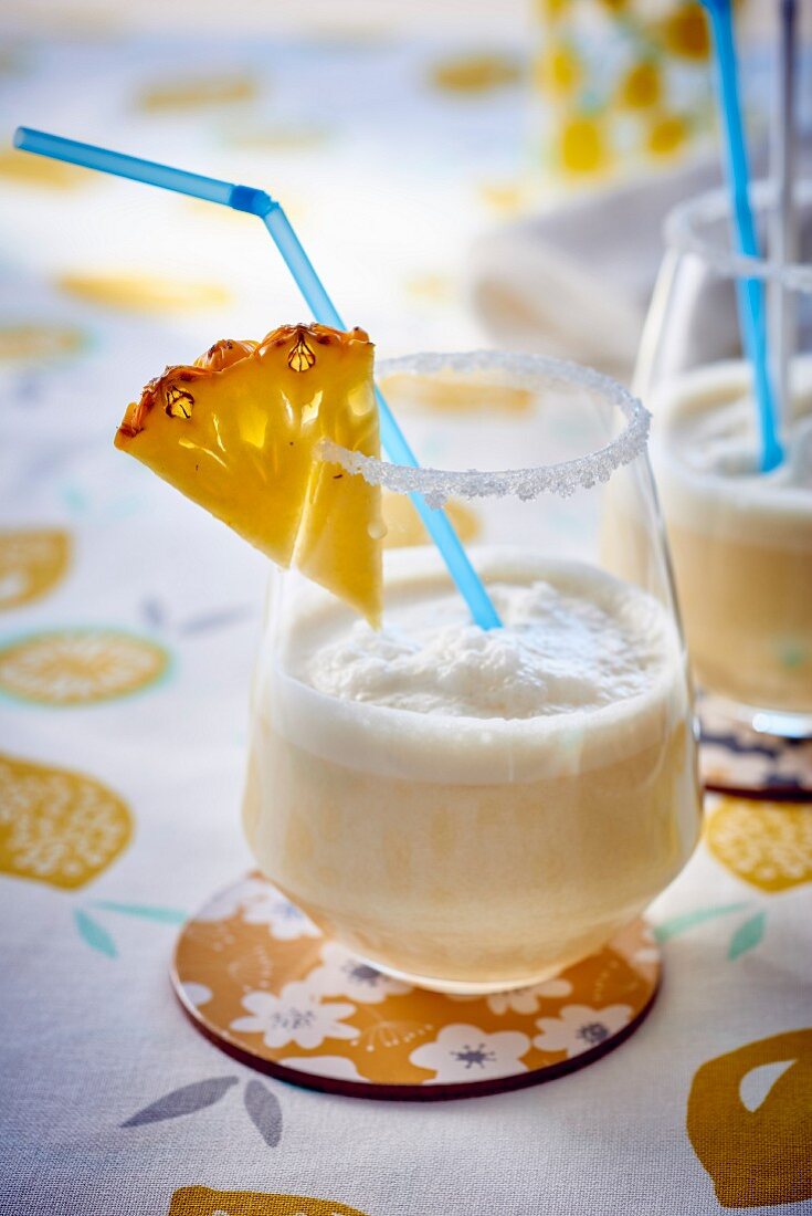 Pina colada cocktails with slices of pineapple