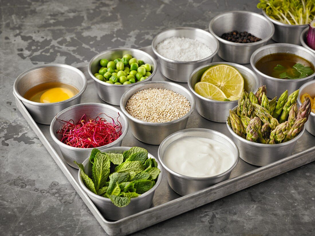 Ingredients for making quinoa burgers and muffins in small bowls