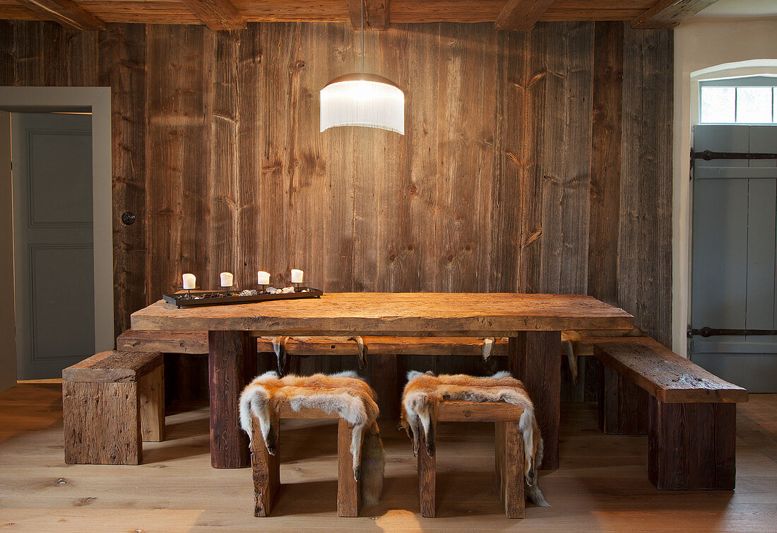 Fox furs on stools in rustic dining room